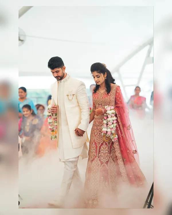 We create magical entrances for your special day. This couple is walking through a cloud of fog we set up, making their reception entry truly feel like a fairytale moment.