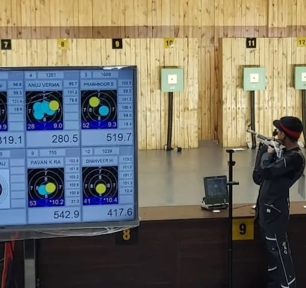 Live scoring displayed on a large screen during the 10-meter air rifle qualification round at the National Championship.