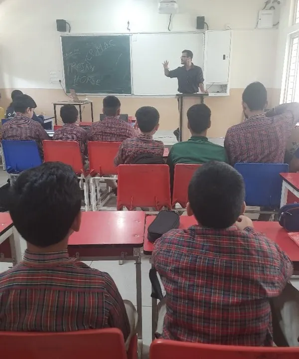 An instructor at DAV Public School Sundernagar explains a cybersecurity concept at the whiteboard. Our workshops are designed to be engaging and informative.