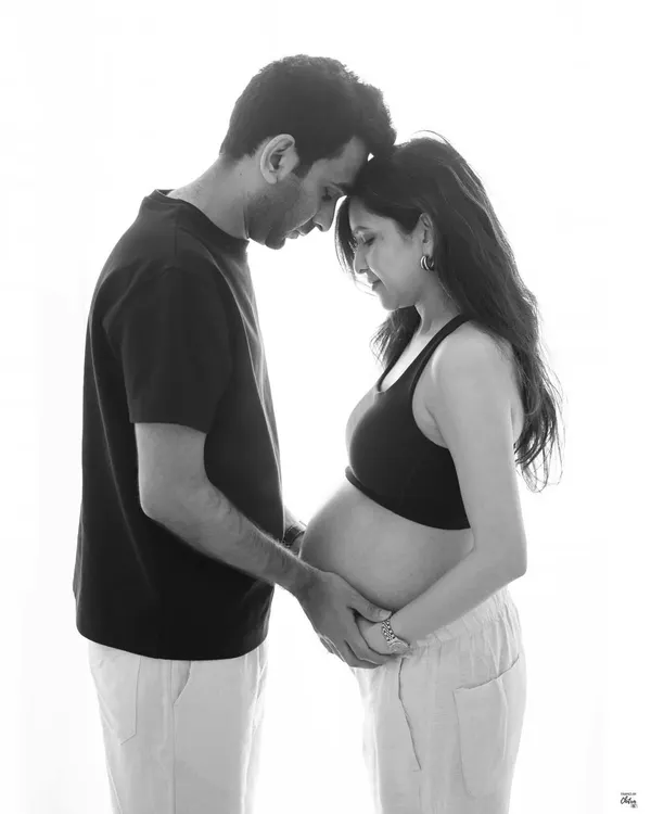 A quiet moment captured in timeless black and white. This is what it's all about: the connection, the anticipation, and the infinite love that already exists between you.