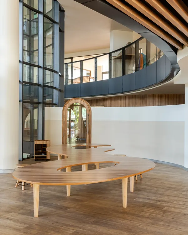 At Vedanya School, a compact site inspired an imaginative design. This image shows how curved forms, double-height volumes, and layered connections create an interconnected environment that encourages movement and exploration for young learners.