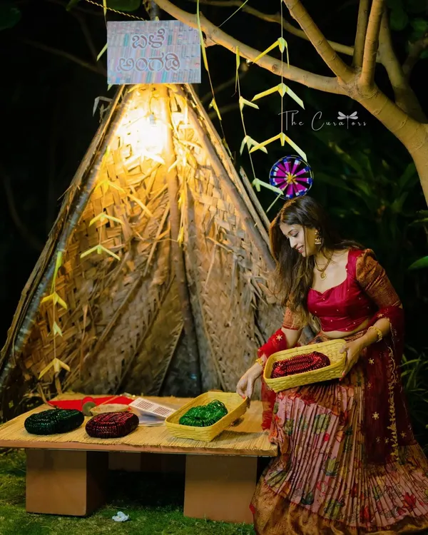 We created this 'Balle Angadi' (bangle shop) photobooth from natural materials, complete with a rustic tent and colorful bangles for guests to try on and take home.