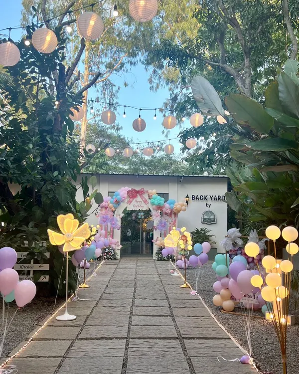 This is how I create a magical journey for your guests. The entrance to this outdoor party was a long, beautifully lit path with glowing flowers and lanterns, leading to the main celebration area.