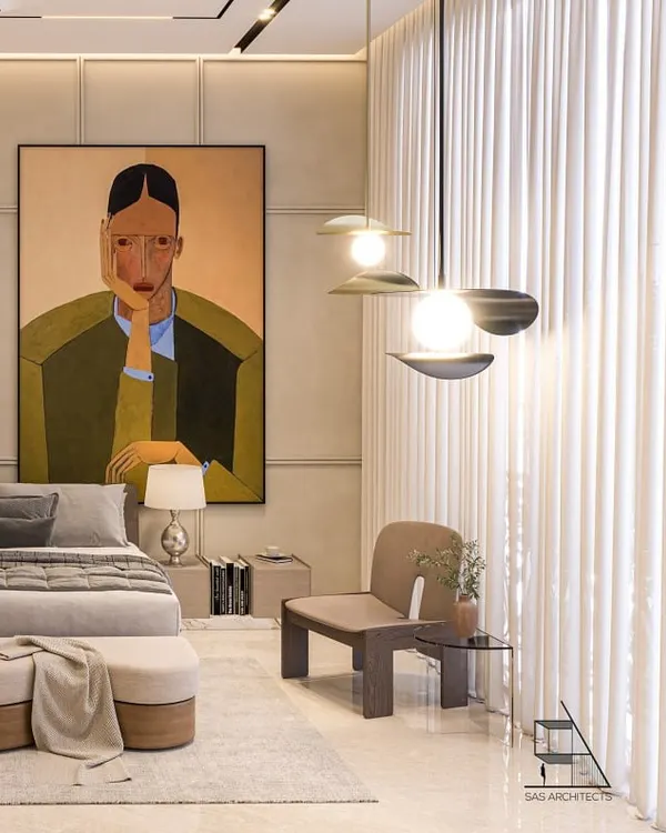 This calm, minimalist bedroom is defined by clean lines, earthy tones, and a large, statement artwork that adds a touch of personality. The layered lighting, including a modern pendant fixture, creates a warm and thoughtfully composed atmosphere.