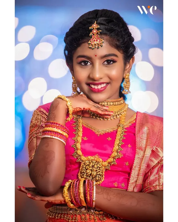 A classic portrait from Harshitha's half-saree ceremony. We work closely with our clients to create beautiful, well-lit portraits that become cherished family heirlooms.