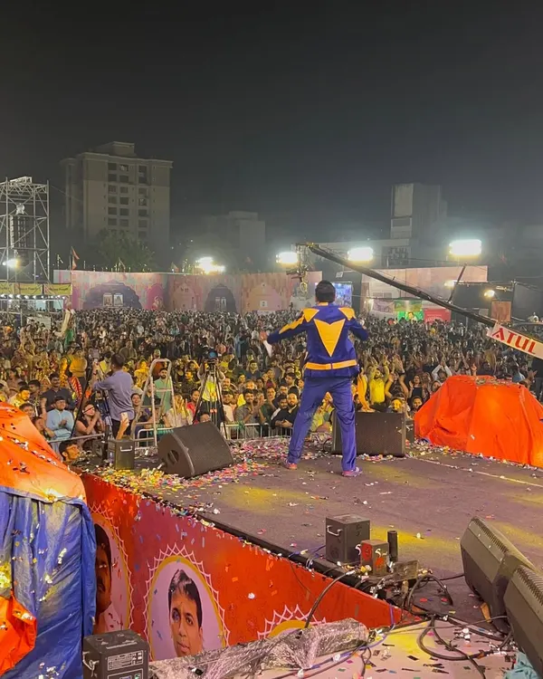 Facing a sea of thousands at a Navratri event. This is my view from the stage, and it's a feeling that never gets old. My job is to make sure every single person in that crowd feels the energy.