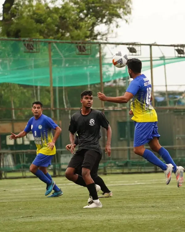 A player rises high to win an aerial duel during our quarter-final match, showing the physical commitment required.