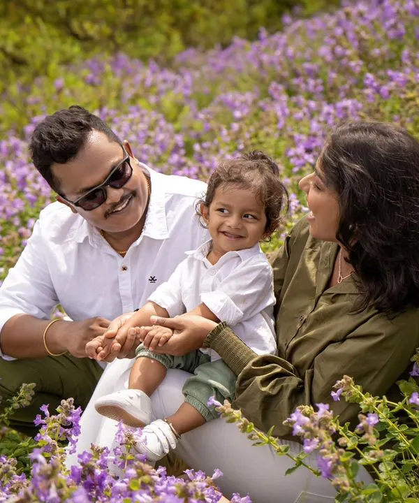 A family enjoying a day out in a field of beautiful Neelakurinji flowers. This once-in-12-years bloom provided a stunning and unique backdrop for this first-year milestone shoot.
