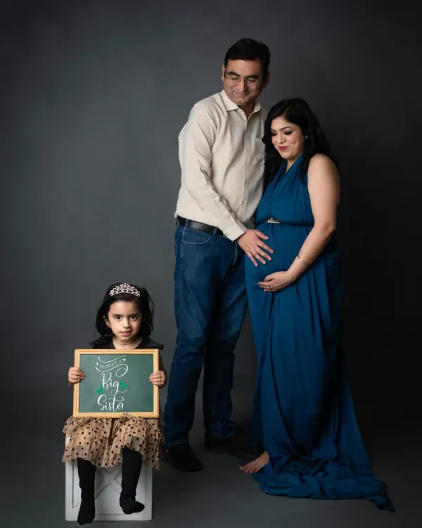 A proud big sister. We love this family portrait where the older sibling holds a "Big Sister" sign, officially announcing her new role.