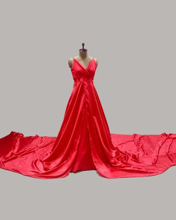 A full view of our popular red satin gown, displaying the expansive trail that brings a 'wow' factor to any maternity photoshoot. This dress is available for rent in both RR Nagar, Bengaluru and Chitradurga.