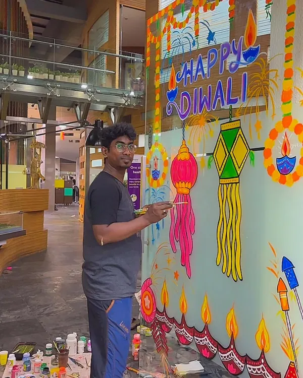 Here I am, live in action, creating a large-scale Diwali mural on a glass partition for an office space in Navi Mumbai. I bring all my own materials and paint directly on the surface, turning any plain window into a festive masterpiece.
