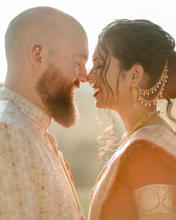 We believe the most powerful stories are found in the quiet moments. This intimate portrait, bathed in the soft glow of the sun, captures the pure, unspoken connection between two people, a perfect blend of cultures united by love.