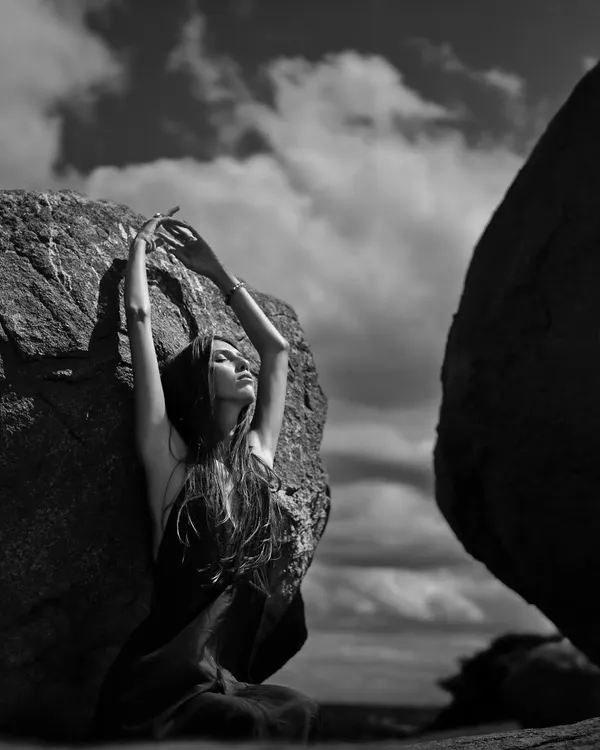 I use black and white to strip away distractions and focus on form and emotion. This shot, set against a dramatic sky, captures a feeling of solitude and strength, ideal for a powerful editorial or brand story.
