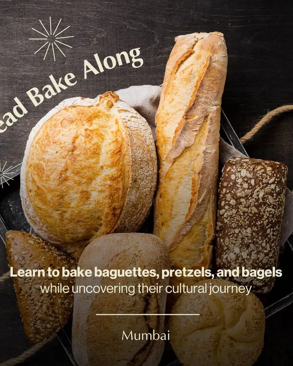 An assortment of freshly baked breads, including a rustic boule and a classic baguette. Our bread bake-along in Mumbai teaches you how to create these artisan loaves at home.