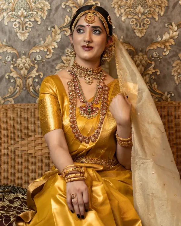 A beautiful bridal portrait from a class demonstration, focusing on traditional jewellery and a golden-hued makeup look.