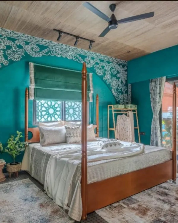 A striking bedroom transformation using a custom mural. I installed this intricate white lace design over a bold teal wall, creating a unique arch effect above the bed for a luxurious, royal look.