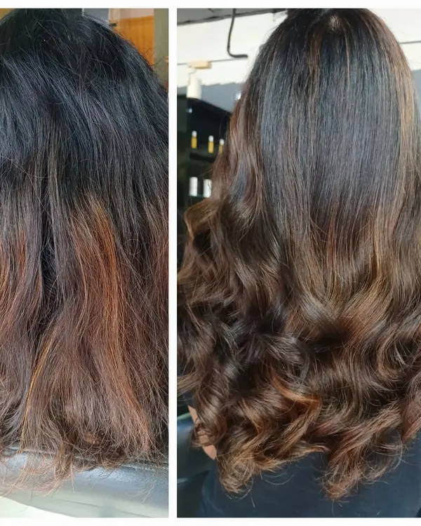 Another example of a successful color correction on hair with a history of dark dye and pre-lightening. The final result is a seamless blend of warm brown tones with subtle highlights, styled into soft waves to show the dimension.