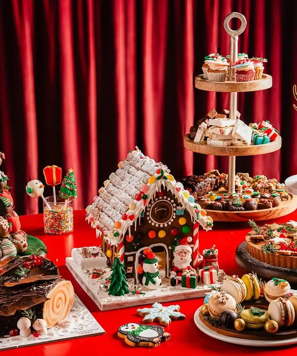 My complete Christmas dessert table is a festive dream. It includes everything from a reindeer cake and gingerbread house to a strawberry tower, Yule logs, macarons, and tarts, perfect for hosting a memorable holiday party.