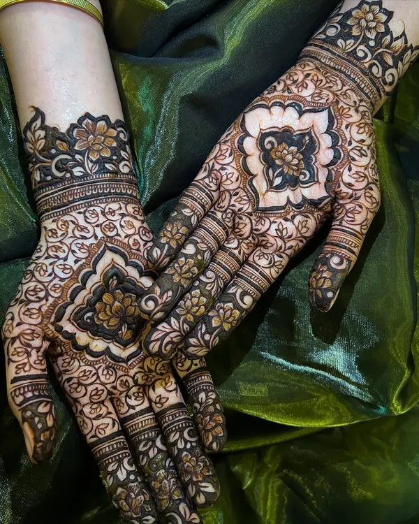 A beautiful flat-lay of a completed design, showcasing the intricate patterns on the palms and the delicate work on the fingers.