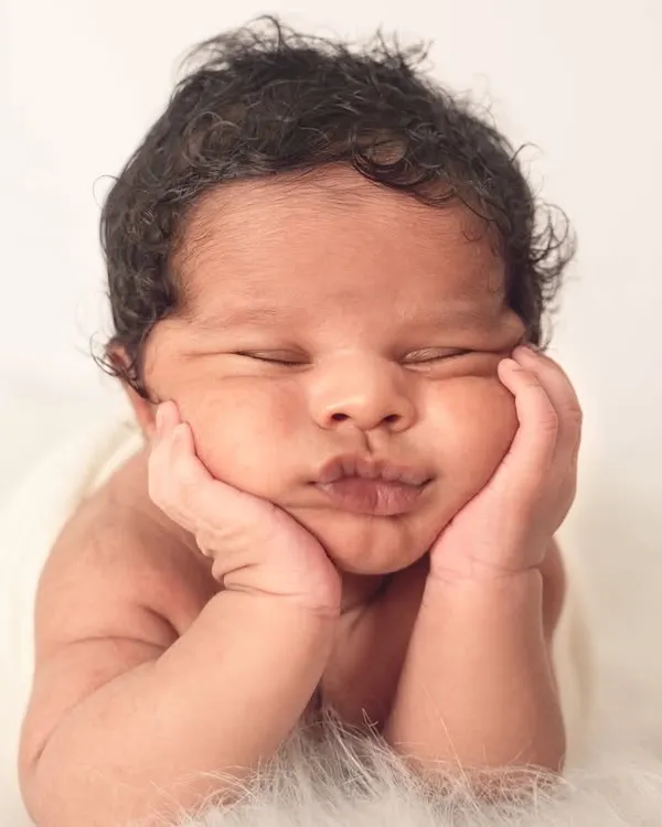 This is the kind of peaceful, perfect moment I live to capture. I use gentle, baby-led posing to photograph your little one in poses that are both adorable and natural, like this classic 'hands-on-cheeks' portrait.