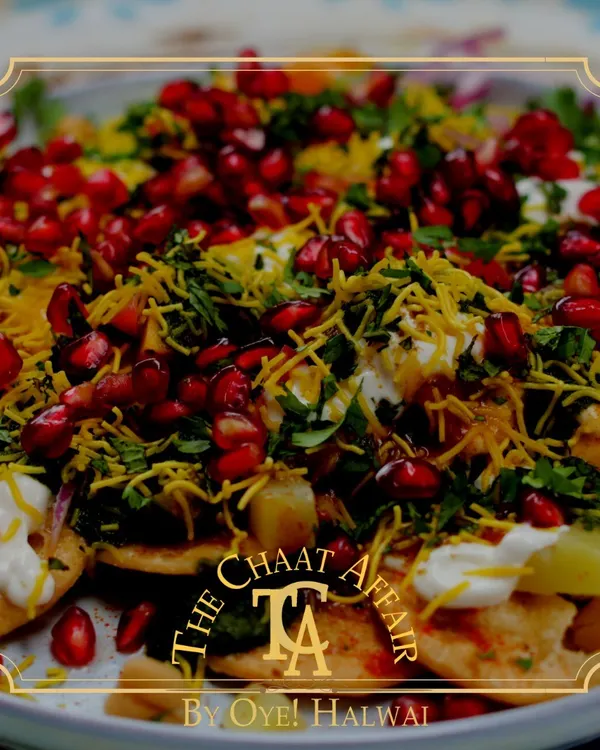Our Papdi Chaat is a symphony of flavors and textures. It's loaded with fresh pomegranate, fine sev, and a perfect balance of sweet and spicy chutneys over a bed of creamy yogurt and crisp papdi.