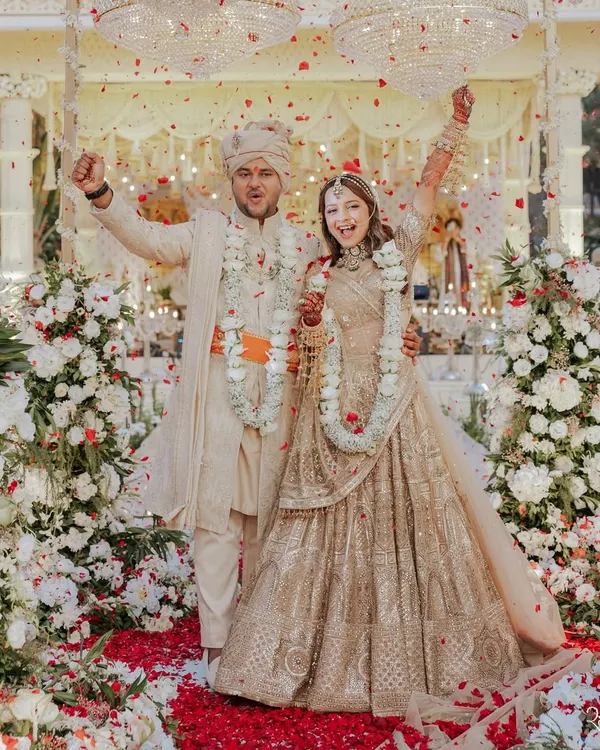 This is what pure joy looks like. For Aashvi and Akash's big day, we created a timeless all-ivory theme. The bride wore a stunning chikankari lehenga by Tarun Tahiliani, and the groom was styled in a coordinated Shantanu & Nikhil sherwani, creating a look of absolute regal elegance.