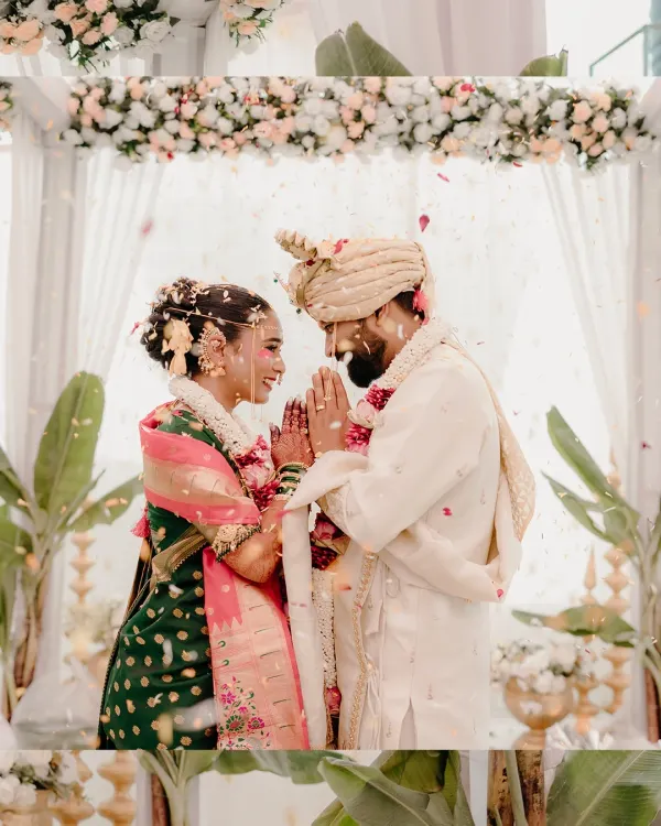 A moment of reverence and mutual respect as the couple greets each other with a 'namaste' during their Maharashtrian wedding ceremony.