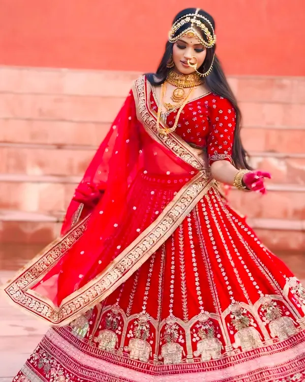 This is the quintessential bridal look. Our classic red lehenga, rich in detail and tradition, is perfect for the bride who wants to feel like royalty on her wedding day. This piece is available for rent, making your dream wedding look a reality.