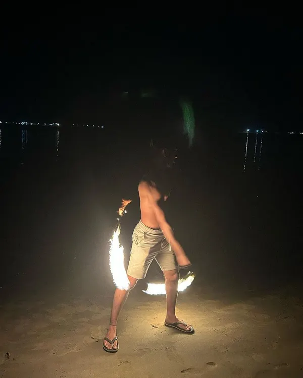 Spinning fire poi on a dark beach is an intense experience. The sound and heat of the flames add a powerful element to the flow. Safety is always the first priority when we get to this level.