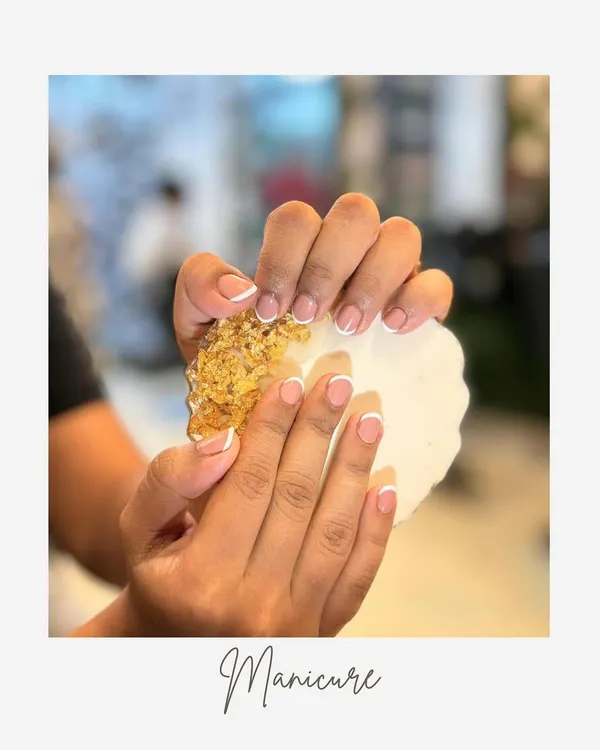 A perfect example of a classic French manicure. The clean white tips and natural pink base on these short, rounded nails create a look of effortless sophistication.