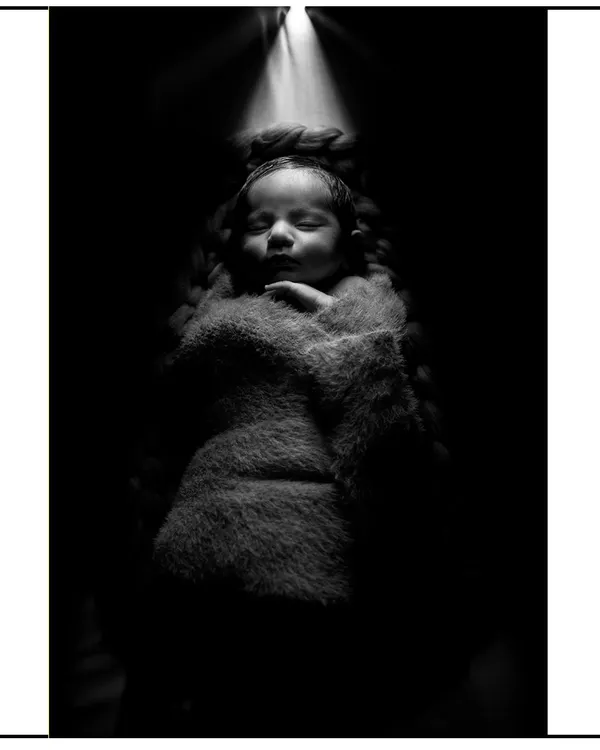 This is an example of my artistic newborn photography. Using dramatic lighting and a soft wrap, I create powerful, fine art portraits that highlight the serene beauty of your sleeping baby.