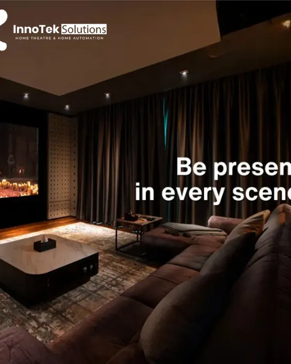 This living room doubles as a high-end cinema with blackout curtains, a large L-shaped sofa for ample seating, and a professionally calibrated sound system.