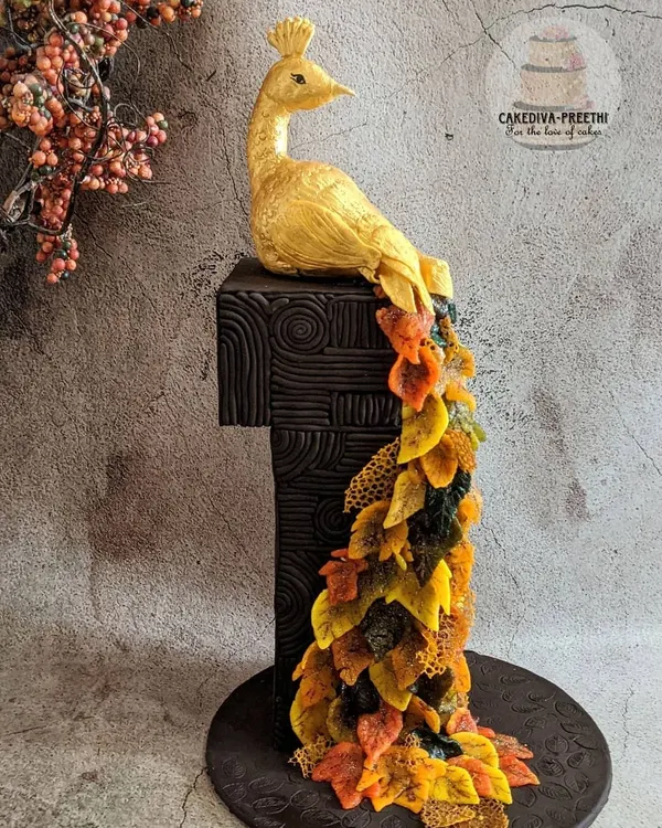 This 24-inch tall, award-winning fondant cake is a true labor of love, featuring a golden peacock with a cascade of autumn leaves made from sugar sheets. It's a perfect example of how I can turn a cake into a breathtaking centerpiece for your most special occasions.