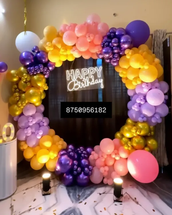 This vibrant circular balloon arch in purple, yellow, and pink makes any birthday pop. Paired with a "Happy Birthday" neon sign and spotlights, it's a fantastic photo corner for your party.