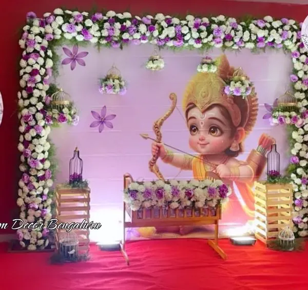 This Ram-themed naming ceremony for a baby boy was so special. The adorable depiction of Ram Lalla, framed by purple and white florals and balloon pillars, created a divine and cute atmosphere.