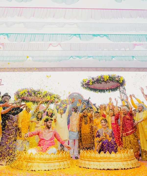 When the brief is "vibrant," we deliver! This 'phoolon ki haldi' was a riot of color, with guests showering the couple in marigold petals under a canopy of bright drapes.