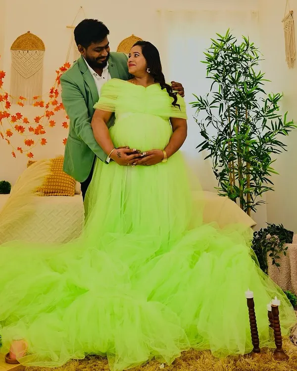 A stunning portrait featuring a vibrant lime green gown against the neutral tones of my Boho bedroom set. The long train of the dress adds a touch of drama to this beautiful maternity photo.
