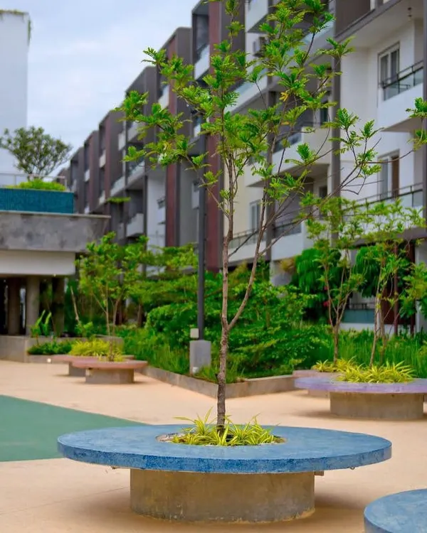 The 'Poetree' apartment complex in Bangalore, where community spaces are given as much importance as private homes. The circular seating around the tree is designed to encourage residents to gather and connect.