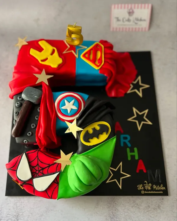 This custom number 5 cake is an Avengers fan's dream, with each section dedicated to a different superhero. I used fondant to create detailed elements like Thor's hammer, Captain America's shield, and Batman's symbol for a truly epic 5th birthday celebration.