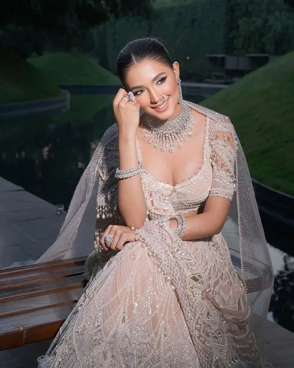 A classic monotone Tarun Tahiliani lehenga, styled for a fresh and elegant bridal look. The intricate embroidery and diamond jewellery create a feeling of timeless royalty.