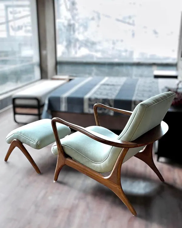This custom armchair and matching ottoman feature elegant, curved teakwood frames, perfect for a serene bedroom corner. The design showcases our skill in creating handcrafted furniture with graceful, organic lines.