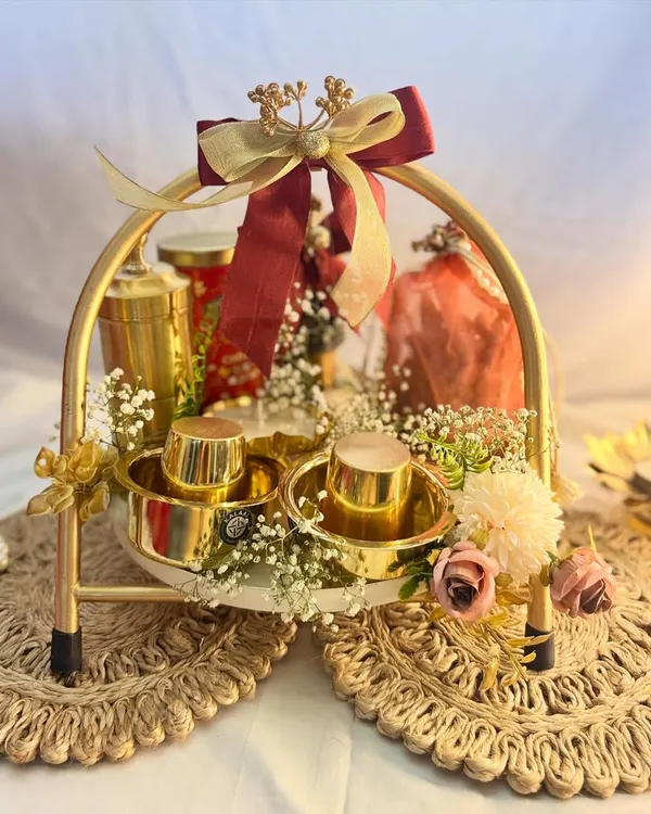 This is my signature Diwali Coffee Lover's Hamper, a perfect example of the luxury and warmth I love to create. It features gleaming brass coffee cups, premium coffee, and other festive treats, all beautifully arranged in a golden arched basket.