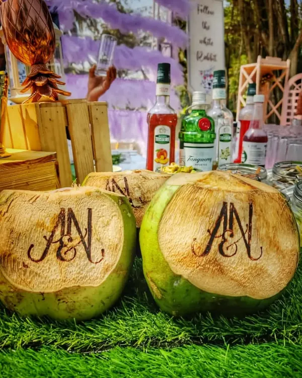 A close-up of my custom engraved coconuts, perfect for adding a personal and tropical touch to your wedding welcome drinks. The couple's initials are elegantly burned into the coconut shell for a memorable first sip.