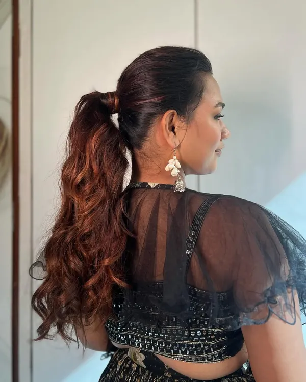 This textured ponytail is perfect for a Sangeet or reception. It keeps the hair off the face for dancing while still showing off beautiful length and volume, thanks to carefully blended extensions.