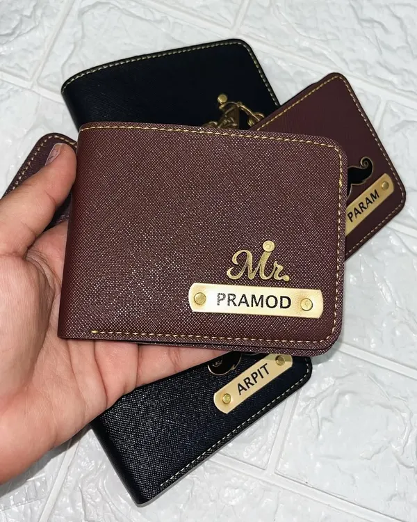 A closer look at my premium personalized wallets for men. This shot shows a collection of wallets in brown and black, each customized with a nameplate and a unique charm, making them a perfect gift for him.