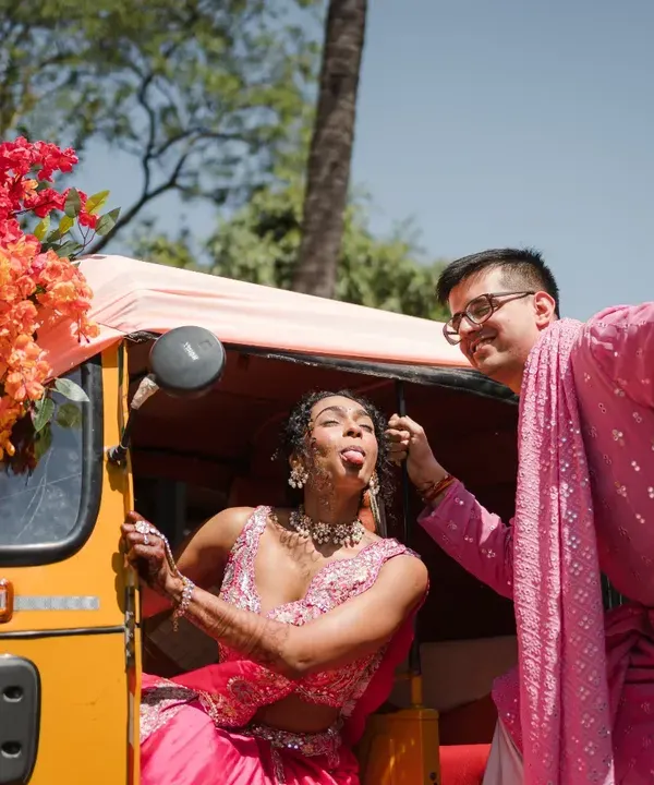 A quirky and fun Haldi moment with a decorated auto-rickshaw. This shot is all about capturing the couple's playful personality and the vibrant energy of the celebration.