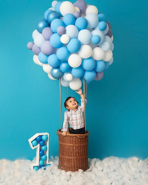 This hot air balloon theme is one of my most requested setups for a first birthday shoot. I love creating these magical, whimsical scenes that celebrate your little one's journey and the adventures yet to come.