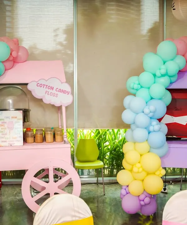 Our matching pastel pink and purple carts for cotton candy and popcorn, decorated with beautiful balloon garlands for a Hello Kitty party.