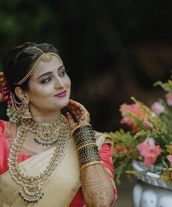A beautiful candid portrait of a bride in her traditional wedding saree and jewellery. I love capturing these natural, in-between moments that show off the bride's personality and the elegance of her complete look.
