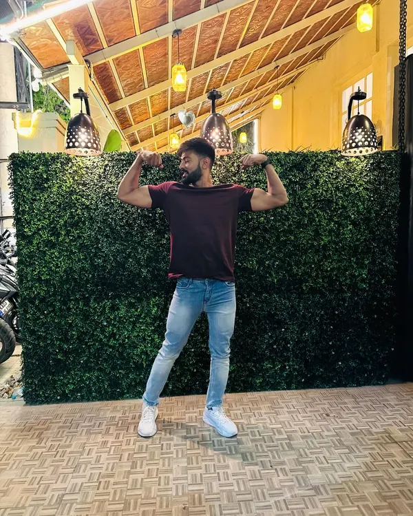 "Chill vibe." Taking a moment to relax and pose outside, showing that fitness is part of my life everywhere.